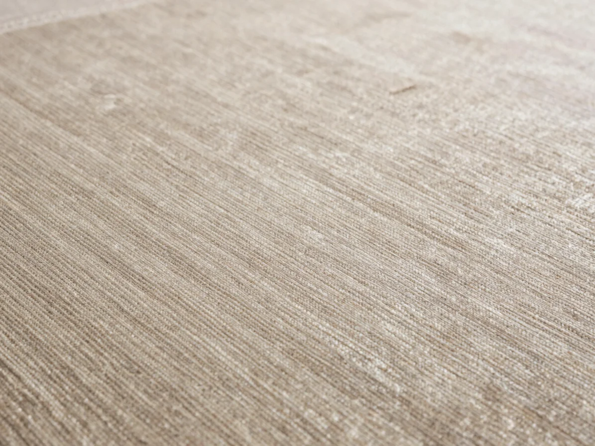 Close material detail of a silk carpet surface showing fine sheen